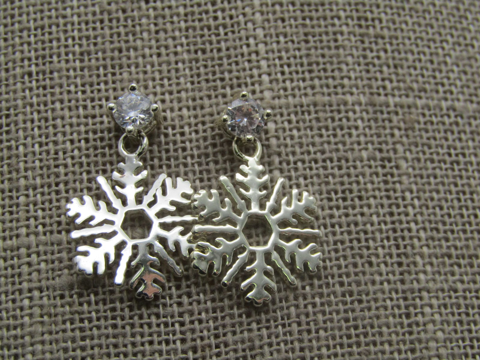 Snowflake Drop Earrings, Rhinestone Stud, 1990's: Snowflake Drop Earrings, Rhinestone Stud, 1990's. Silver tone snowflake drops with an appx. 4mm round clear rhinestone stud. Surgical steel posts. These are not signed are marked. Very good condition.