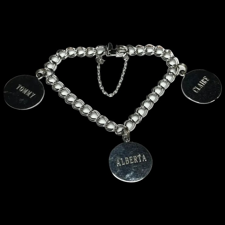 Vintage Sterling Silver Customize Charm Bracelet: Title: Vintage Sterling Silver Customize Charm Bracelet Description: Vintage Sterling Silver Customize Charm BraceletHallmarked: TC SterlingCustomized: Claire Dec. 13, Alberta Jan. 20, Tommy Aug. 14We