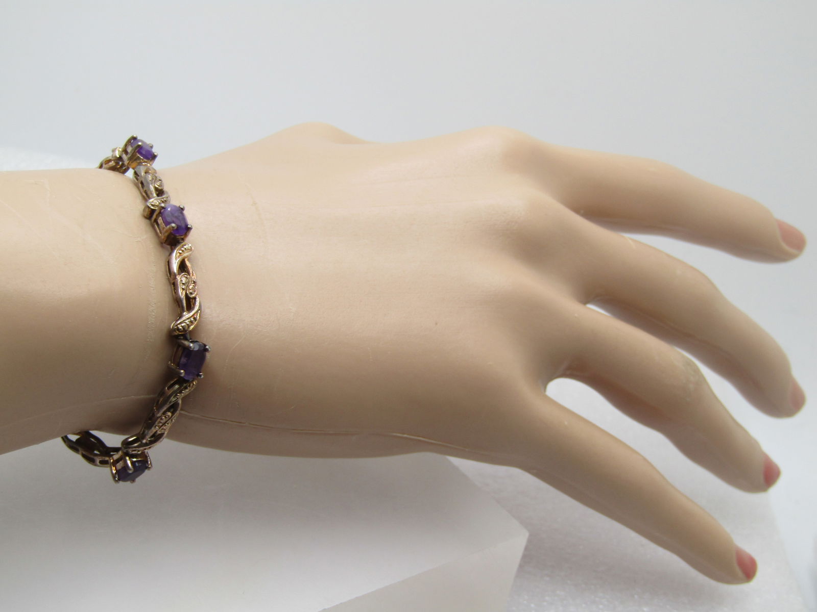 Vintage Amethyst Tennis Bracelet 7.25", Illusion Box Clasp, Safety Clips, 1980's-1990's: Vintage Amethyst Tennis Bracelet 7.25", Illusion Box Clasp, Safety Clips. 1980's-1990's This is silver plated with amethyst stones that are appx. 6mm by 4mm. This does test with silver content but are