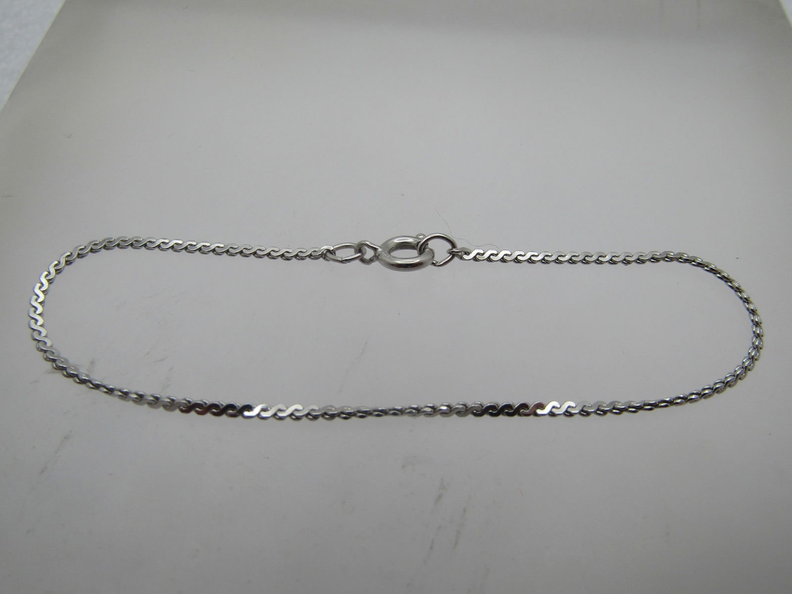 Silver Tone Herringbone Bracelet, 6.5", Signed A1: Silver Tone Herringbone Bracelet, 6.5", Signed A1. This is marked sterling but does not test as sterling. It is appx. 1mm wide with spring clasp. Very clean and in very good condition but it is not st