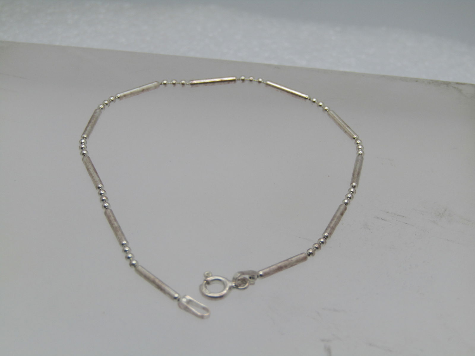 Sterling Bar & Ball Link Bracelet, 7.5", Italy , 1990's. Unisex: Sterling Bar & Ball Link Bracelet, 7.5", Italy , 1990's. Unisex It is marked .925, spring clasp. It is an appx. width of 1.5mm. It has a mild magnetic reaction but tests as sterling - it is likely a m