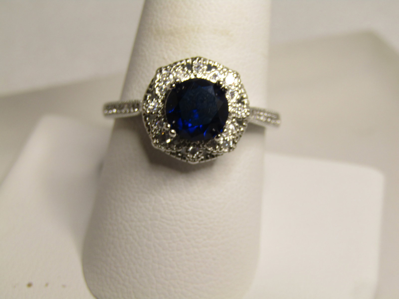 Silver Tone Blue & Clear Stone Ring, Sz. 9.5, 2000-2010: Silver Tone Blue & Clear Stone Ring, Sz. 9.5, 2000-2010, Cocktail/Engagement Style . The stones are crystal or glass. The main stone is a sapphire blue glass stone that is appx. 6.8mm rund held with f
