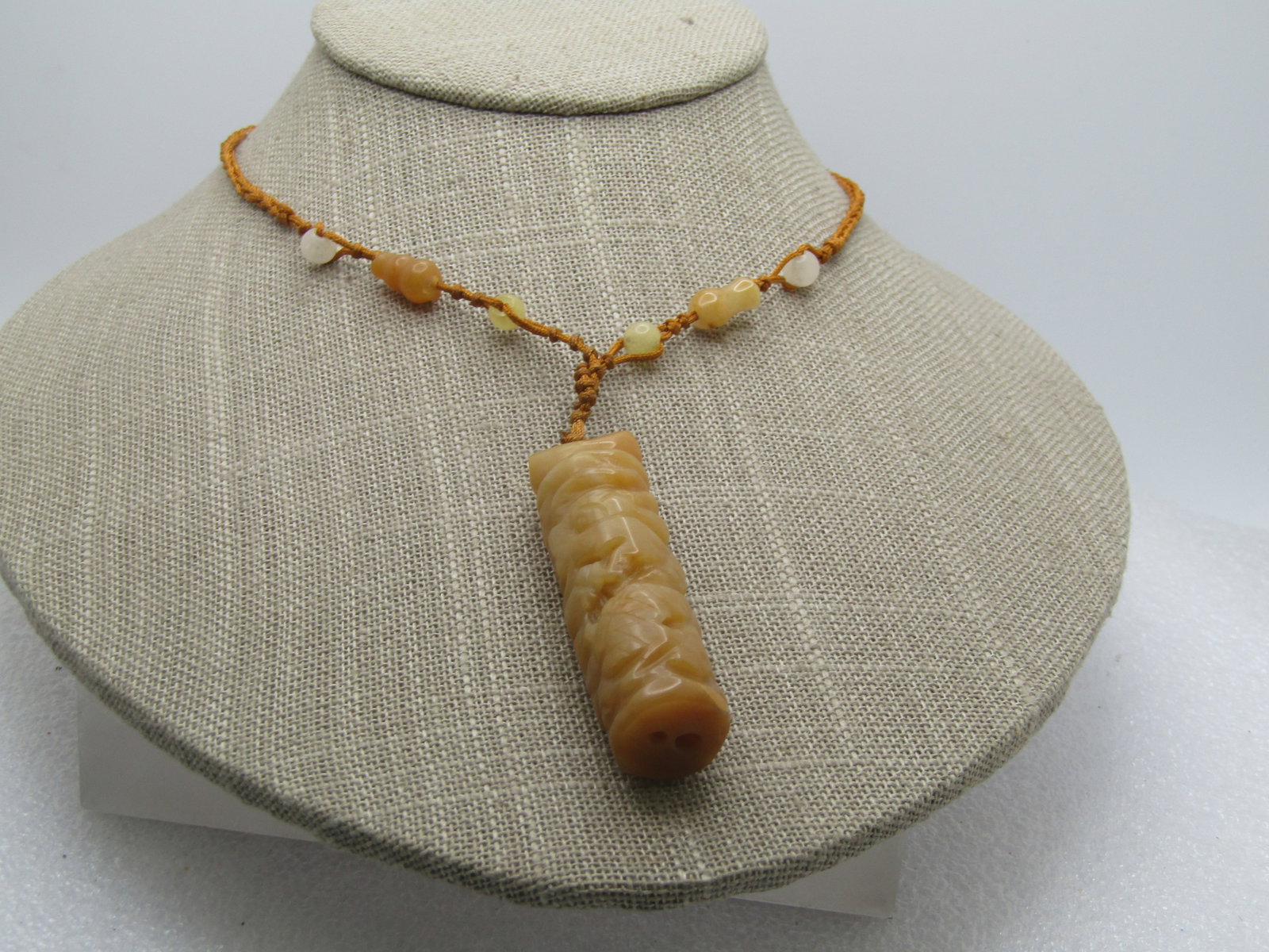 Vintage Carved Brown Jade Necklace, 24" Cord Necklace, Adj. , 1980's, Unisex: Vintage Carved Brown Jade Necklace, 24" Cord Necklace, Adj. , 1980's. or possibly earlier. The pendant is a carved brownround pendnt that appears to be a dragon wrapping around the cylindrical design.
