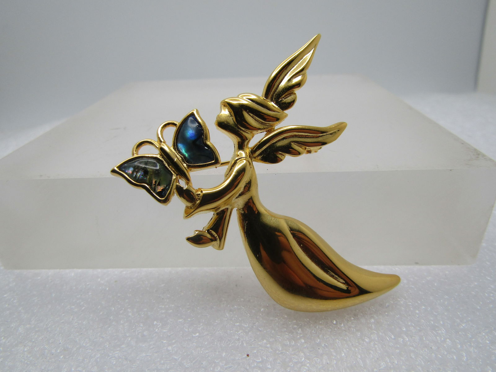 Vintage Angel & Abalone Butterflry Brooch, Signed Camco 1980's-1990's: Vintage Angel & Abalone Butterflry Brooch, Signed Camco 1980's-1990's. Large floating angel in gold tone holding a butterfly with abalone wings. It is appx. 2.5" wide and 2" tall. Signed Camco. Very g