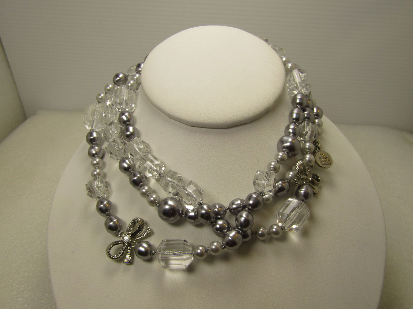 Vintage Clear, Silver Necklace, Faux Pearl and Crystal, 22", with Bows, Liz Claiborne, 1990's: Vintage Clear, Silver Necklace, Faux Pearl and Crystal, 22", with Bows, Liz Claiborne, 1990's. This has a tag signed LC EST. 1976. This is believed to be Liz Claiborne as that is also when the company