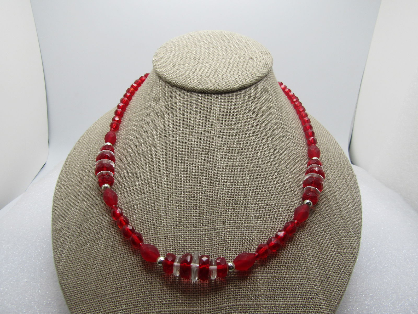 Vintage Red & Clear Glass Necklace, 18", 1940's-1960's: Vintage Red & Clear Glass Necklace, 18", 1940's-1960's. The beads at the back and sides of the neck are appx. 5.5mm wide. Ruby red and faceted. At the front of the neck there are three clusters of gra