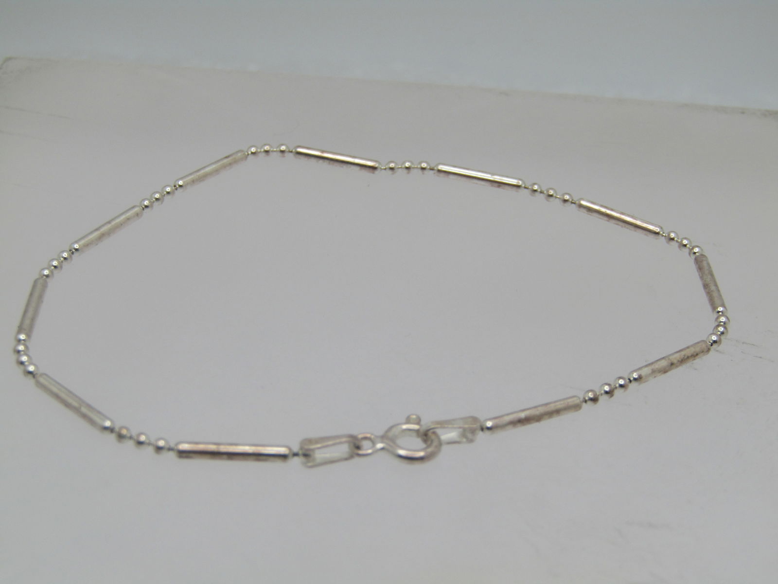 Sterling Bar & Ball Link Bracelet, 7.5", Italy , 1990's. Unisex: Sterling Bar & Ball Link Bracelet, 7.5", Italy , 1990's. Unisex It is marked .925, spring clasp. It is an appx. width of 1.5mm. It has a mild magnetic reaction but tests as sterling - it is likely a m