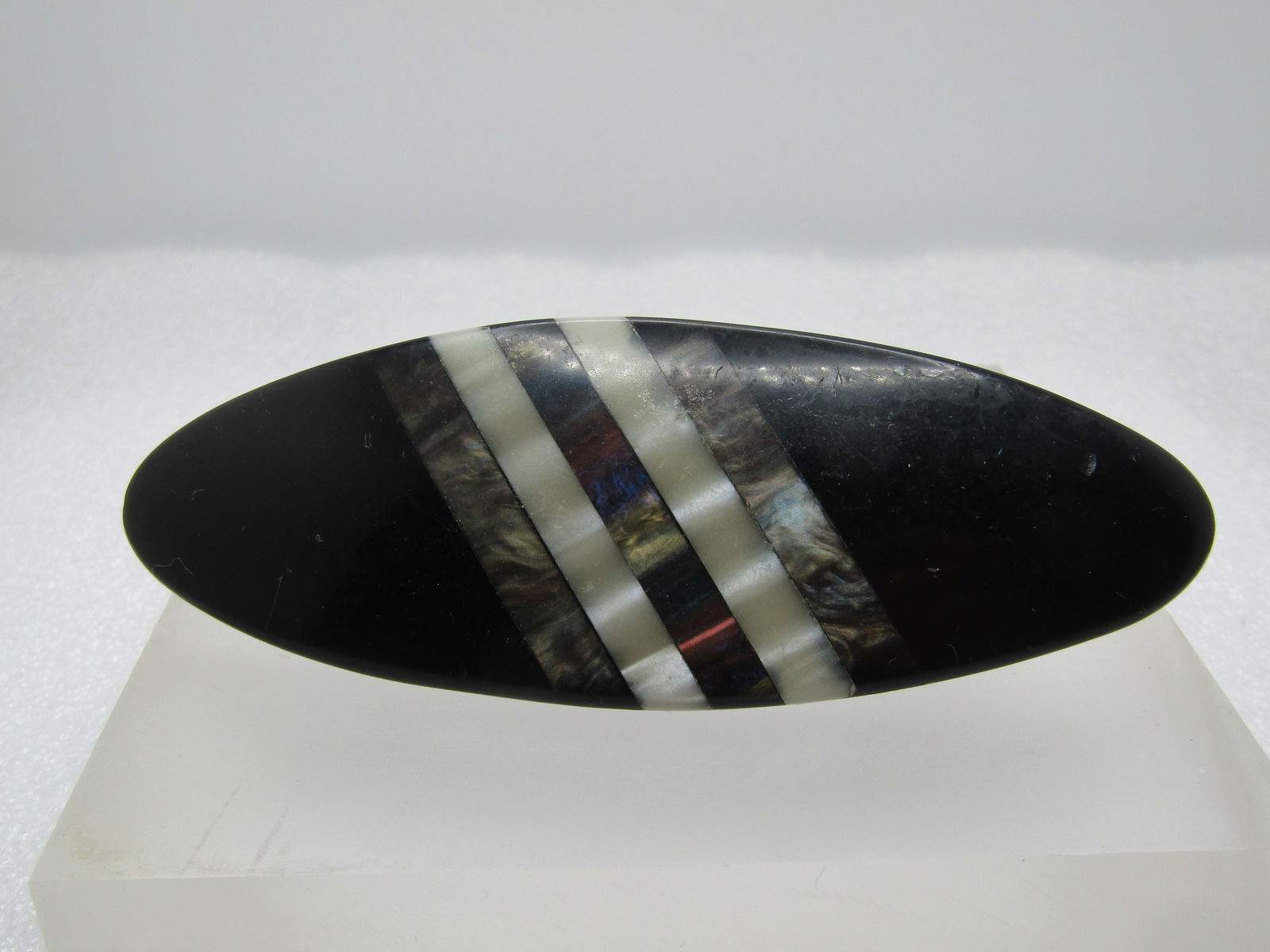 Vintage Inlaid Mother-of-Pear Abalone Barrette, 1960's-1980's: Vintage Inlaid Mother-of-Pear Abalone Barrette, 1960's-1980's. It is an elongated oval - cat-eye shaped and is 4.25" long and 1.5" wide. Sturdy hinged and locking clip set in black resin/plastic with