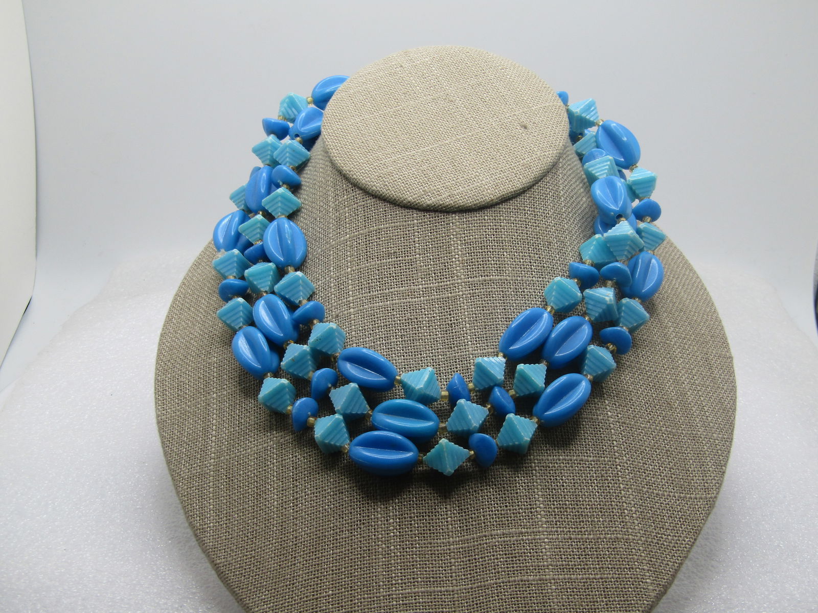 Vintage Blue Beaded Necklace, Mixed Shapes, 1950's-1960's, 24": Vintage Blue Beaded Necklace, Mixed Shapes, 1950's-1960's, 24". This is a plastic beaded necklace in what looks like two turquoise pyramids together and then blue ridged oval beads and blue nuggetlike