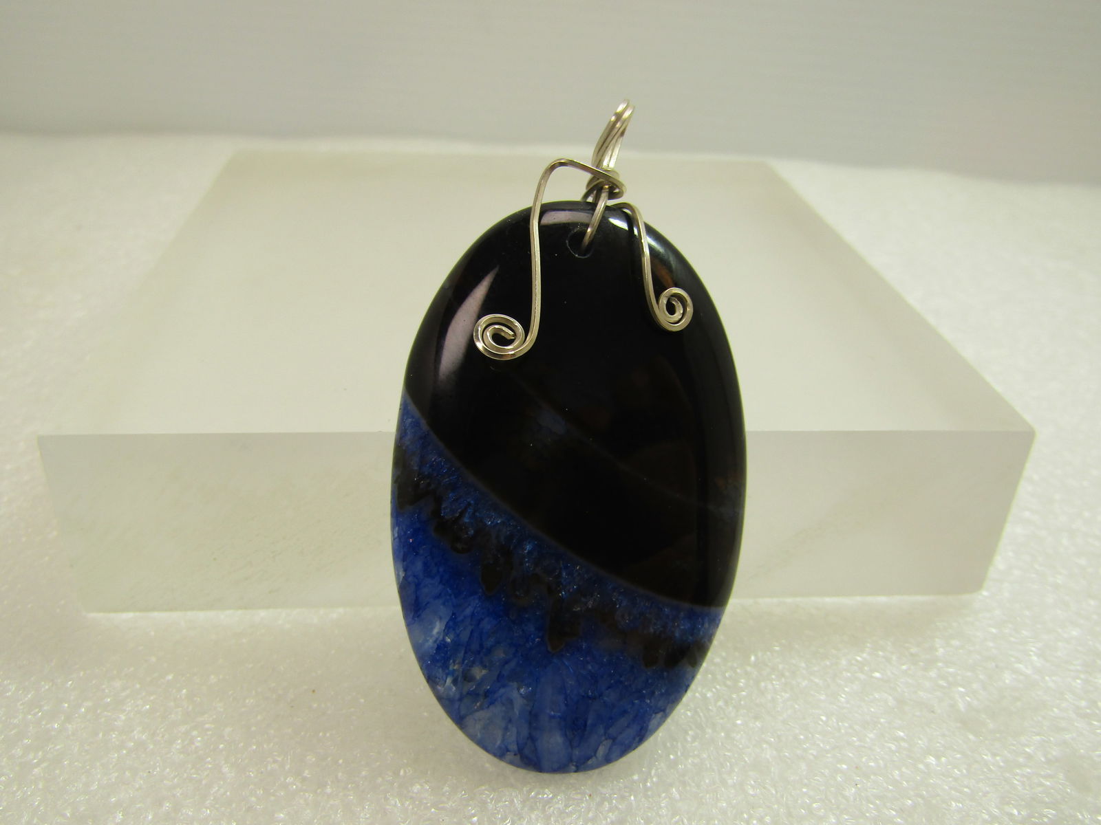 Silver Wrapped Black Line Agate Stone Pendant, 1980's-1990's: Silver Wrapped Black Line Agate Stone Pendant, 1980's-1990's. This has a blue crystal bottom half. Beautiful stone that is appx. 2.25" tall and 1.25" wide with a coild silver plated decorative bail. V
