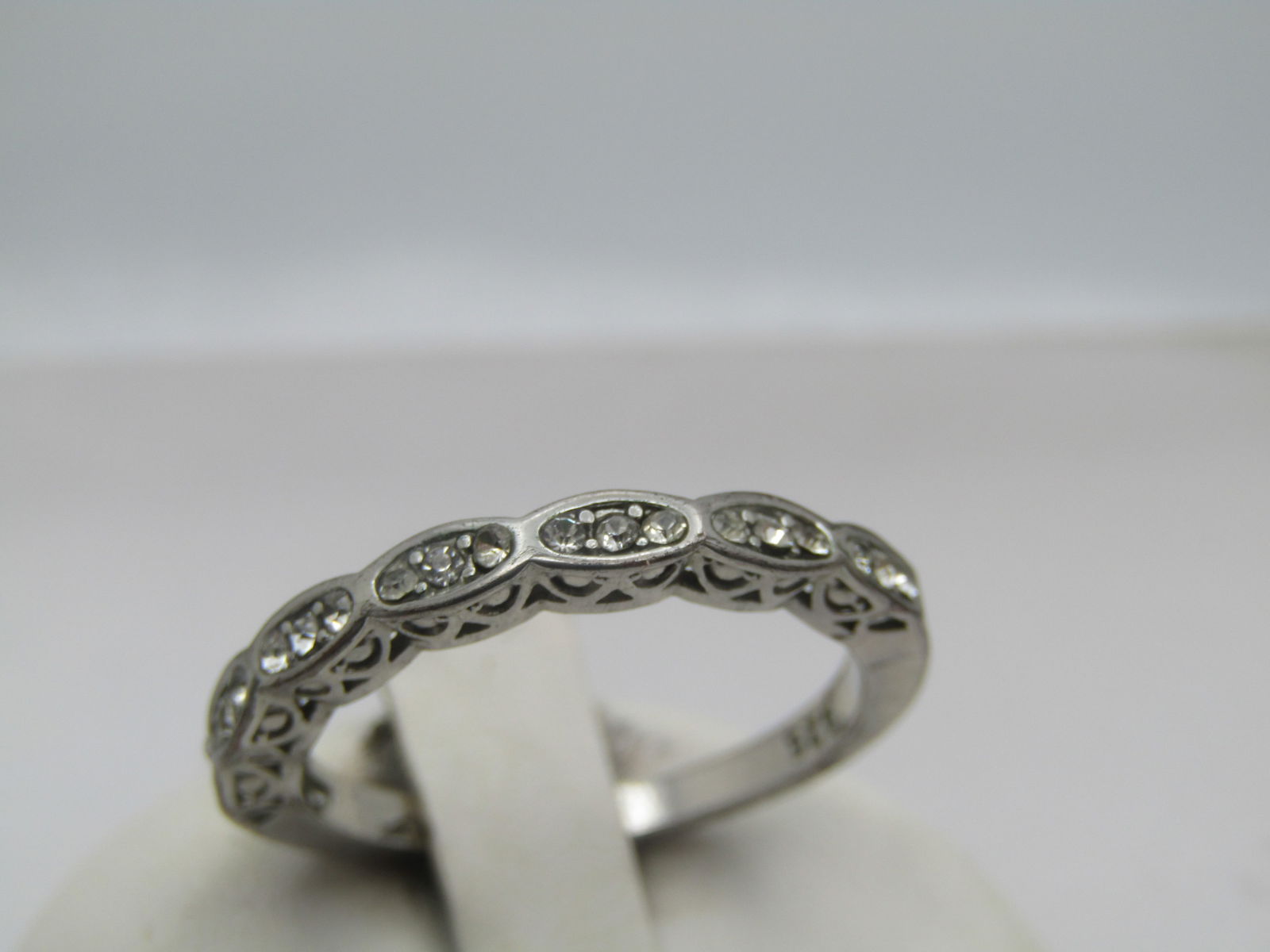 Vintage Clear Rhinestone Filigree Band/Ring, Sz. 9.75, 1990's: Vintage Clear Rhinestone Filigree Band/Ring, Sz. 9.75. 1990's. This is marked .925 but it is not sterling - it is silver tone plating over copper. It has seven oval accents across the top of the finge