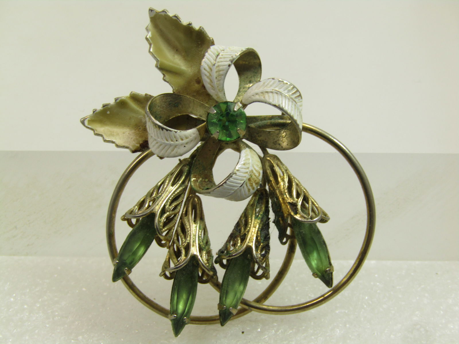 Vintage Enameled Green Navette Floral Brooch, 1940's: Vintage Enameled Green Navette Floral Brooch, 1940's. This is gold tone with four lily-like blossoms with filigree gold tone outer and a long green glass navette in the center of each that sticks out
