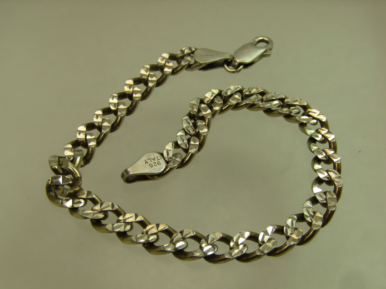 Vintage Sterling Notched Curb Link Bracelet, 7.5", Danecraft, 1980's, Unisex: Vintage Sterling Notched Curb Link Bracelet, 7.5", Danecraft, 1980's. Unisex. This is appx. 5.5mm wide with a lobster clasp and signed Danecraft and marked .925 Italy. It tests as sterling with an app