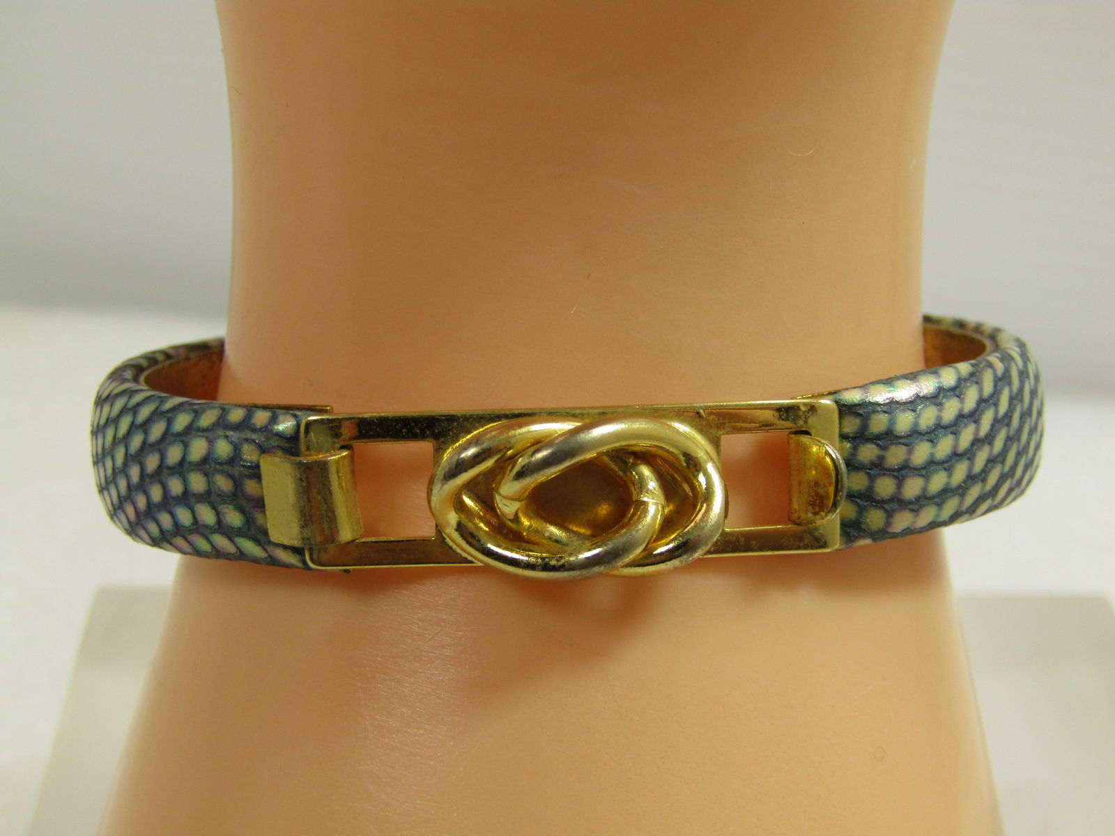 Vintage Faux Snakeskin Bangle Bracelet, 6.5, Italy, 1980's: Vintage Faux Snakeskin Bangle Bracelet, 6.5, Italy, 1980's. Gold tone center with padded rounded fax snakeskin in blue/white with a shimmery finish to the faux scales. This has a top opening hook clas