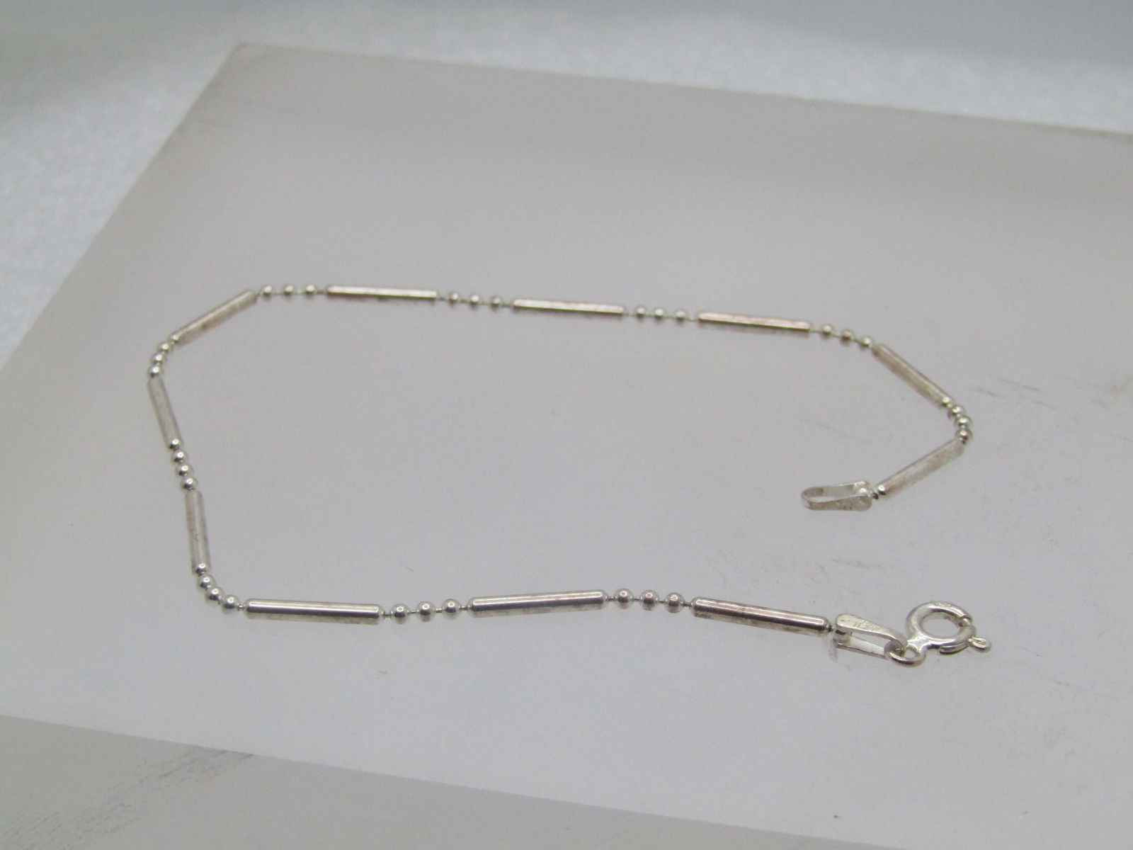 Sterling Bar & Ball Link Bracelet, 7.5", Italy , 1990's. Unisex: Sterling Bar & Ball Link Bracelet, 7.5", Italy , 1990's. Unisex It is marked .925, spring clasp. It is an appx. width of 1.5mm. It has a mild magnetic reaction but tests as sterling - it is likely a m