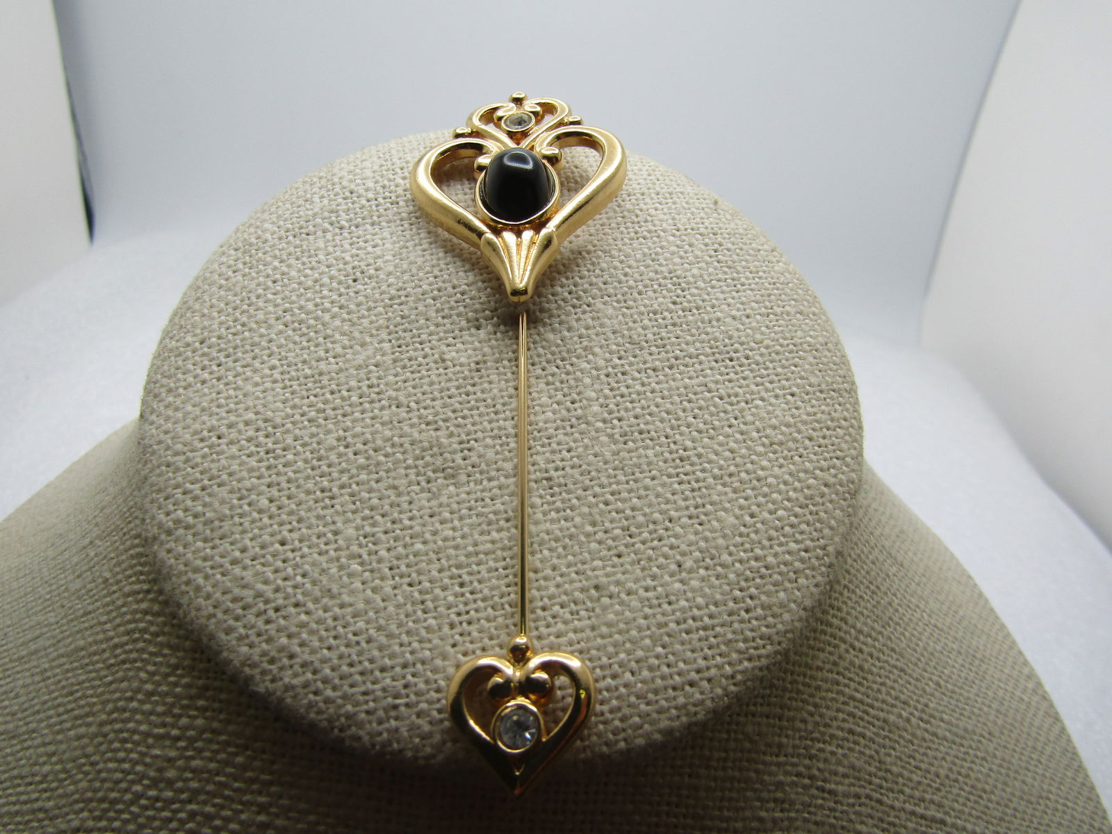 Vintage Black & Clear Rhinestone Stick Pin, Safety Cap, 1980's: Vintage Black & Clear Rhinestone Stick Pin, Safety Cap, 1980's. A scrolled heart like top with a clear rhinetone and black acrylic oval cabochon. The safety cap has a scrolled heart in the design with