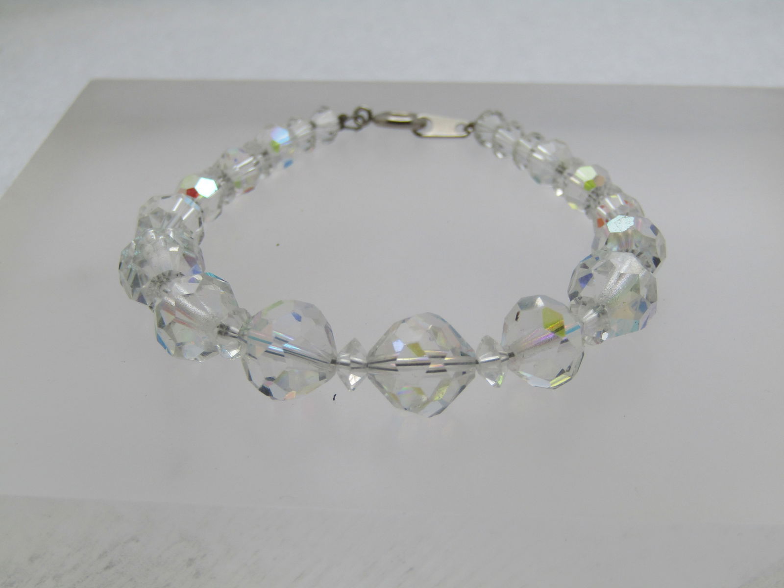 Vintage Aurora Borealis Crystal Bracelet, 7.5", 1940's-1960's, Graduated: Vintage Aurora Borealis Crystal Bracelet, 7.5", 1940's-1960's, Graduated from 5mm to 9.5mm. Spring clasp. Not signed by the maker. Nice shimmer and in very good condition. (W31823.1X1 SS10721 J LD 5/2
