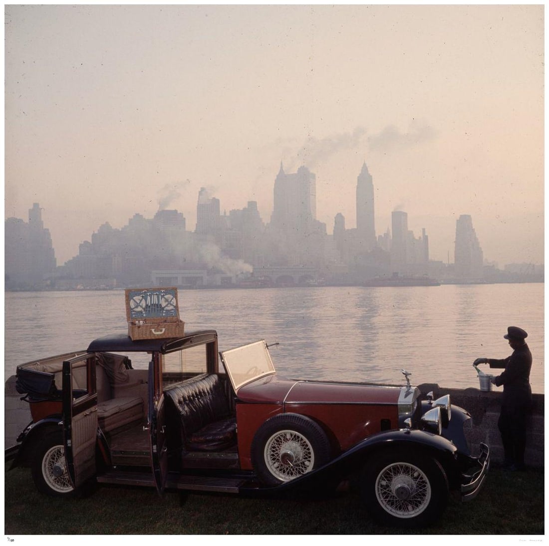 New York Picnic 1952 - Slim Aarons: 1952 (printed later): Title: New York Picnic 1952 - Slim Aarons: 1952 (printed later) Description: New York Picnic 1952 - Slim Aarons A chauffeur unpacks a picnic hamper from a Rolls Royce, against the New York skyline. 19