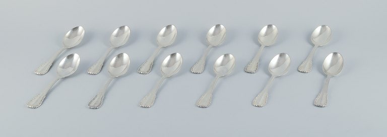 Georg Jensen, Viking, a set of twelve dessert spoons in sterling silver and 830 silver.: Title:Georg Jensen, Viking, a set of twelve dessert spoons in sterling silver and 830 silver. Description:Georg Jensen, Viking, a set of twelve dessert spoons in sterling silver (7) and 830 silver (5)