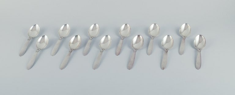 Georg Jensen, Kaktus, a set of twelve sterling silver dessert spoons.: Title:Georg Jensen, Kaktus, a set of twelve sterling silver dessert spoons. Description:Georg Jensen, Kaktus, a set of twelve sterling silver dessert spoons. Stamped with the post 1944 hallmark. In ex