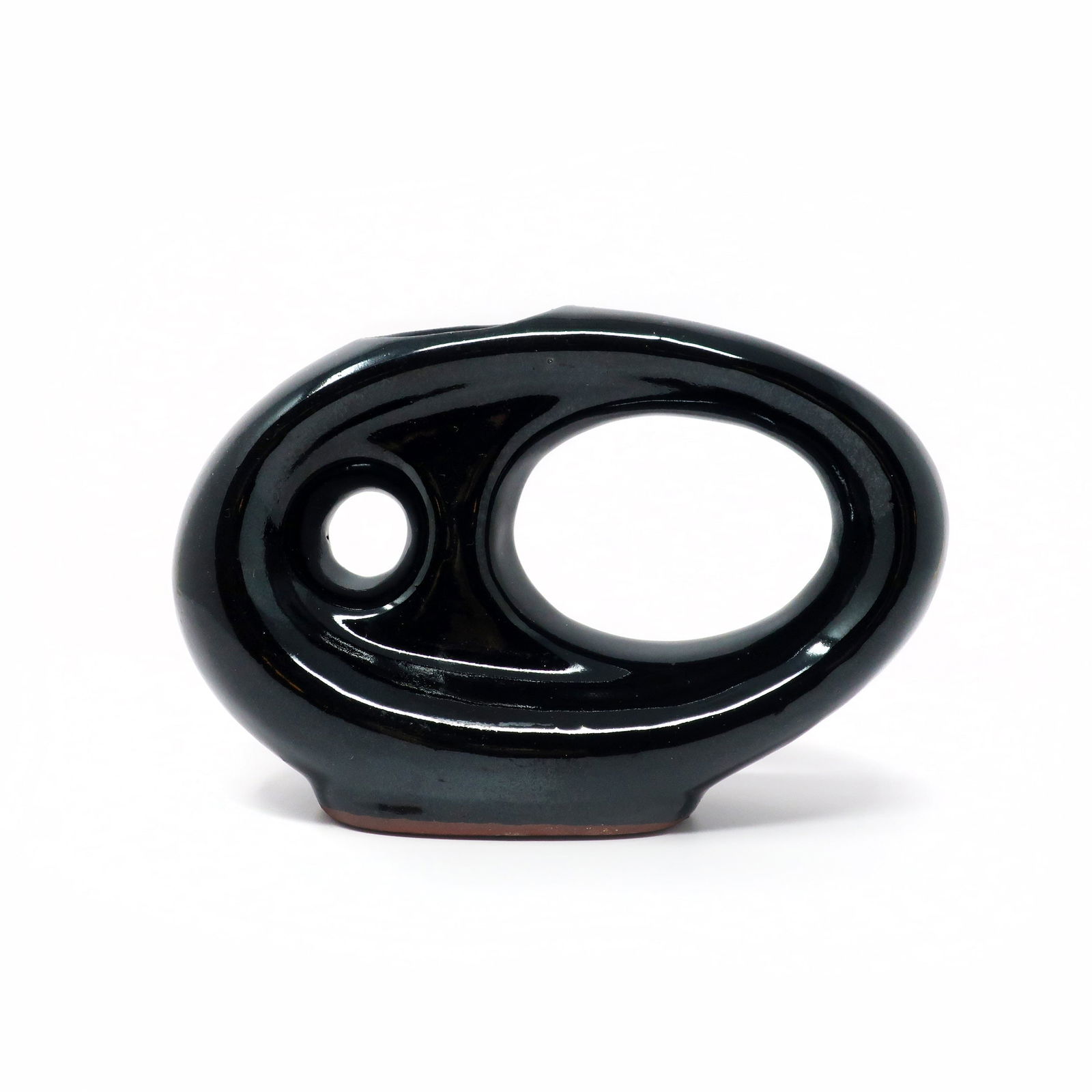 Vintage Asymmetrical Black Pottery Vase: A charmingly mid-century or post modern asymmetrical pottery vase with shades of a flying V guitar. Glossy black glaze with no maker's mark. In very good vintage condition. 7.5" x 3" x 5.5" Reserve: $