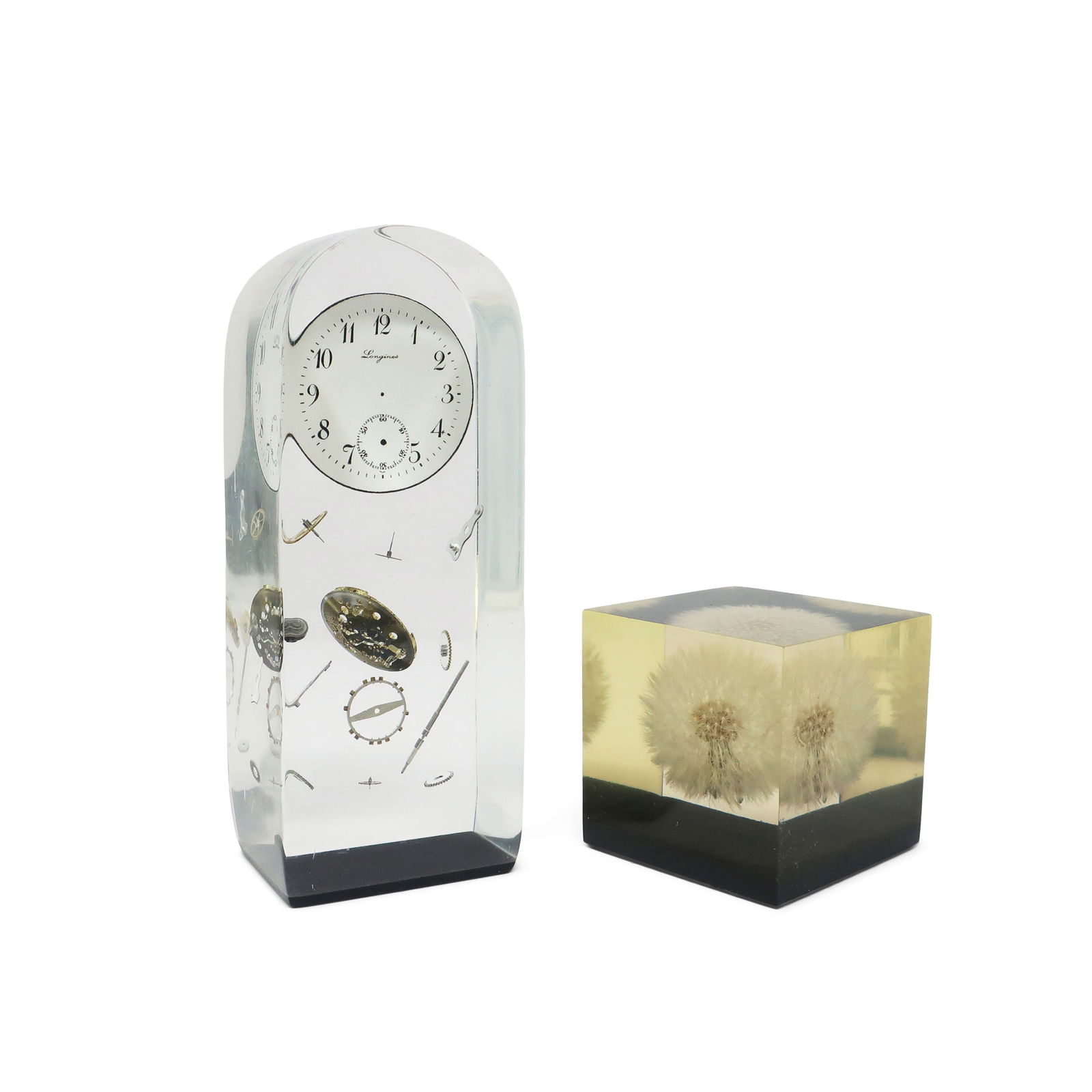 Set of Vintage Lucite Encased Paperweights: A great set of vintage, mid-century modern lucite encased paperweights, one from the 1960s with a dandelion and another with clock parts. Beautiful and eye-catching, they're great as decor on a shelf,
