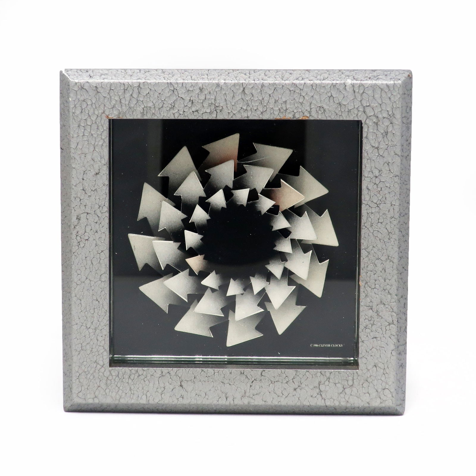 1986 Postmodern Desk Clock by Douglas Chalk for Clever Clocks: A rare 1986 desk clock designed by Douglas Chalk for Clever Clock. A silver/gray square wood case, a series of arrows making pinwheels for the hands (one arrow in each is colored so the viewer can see