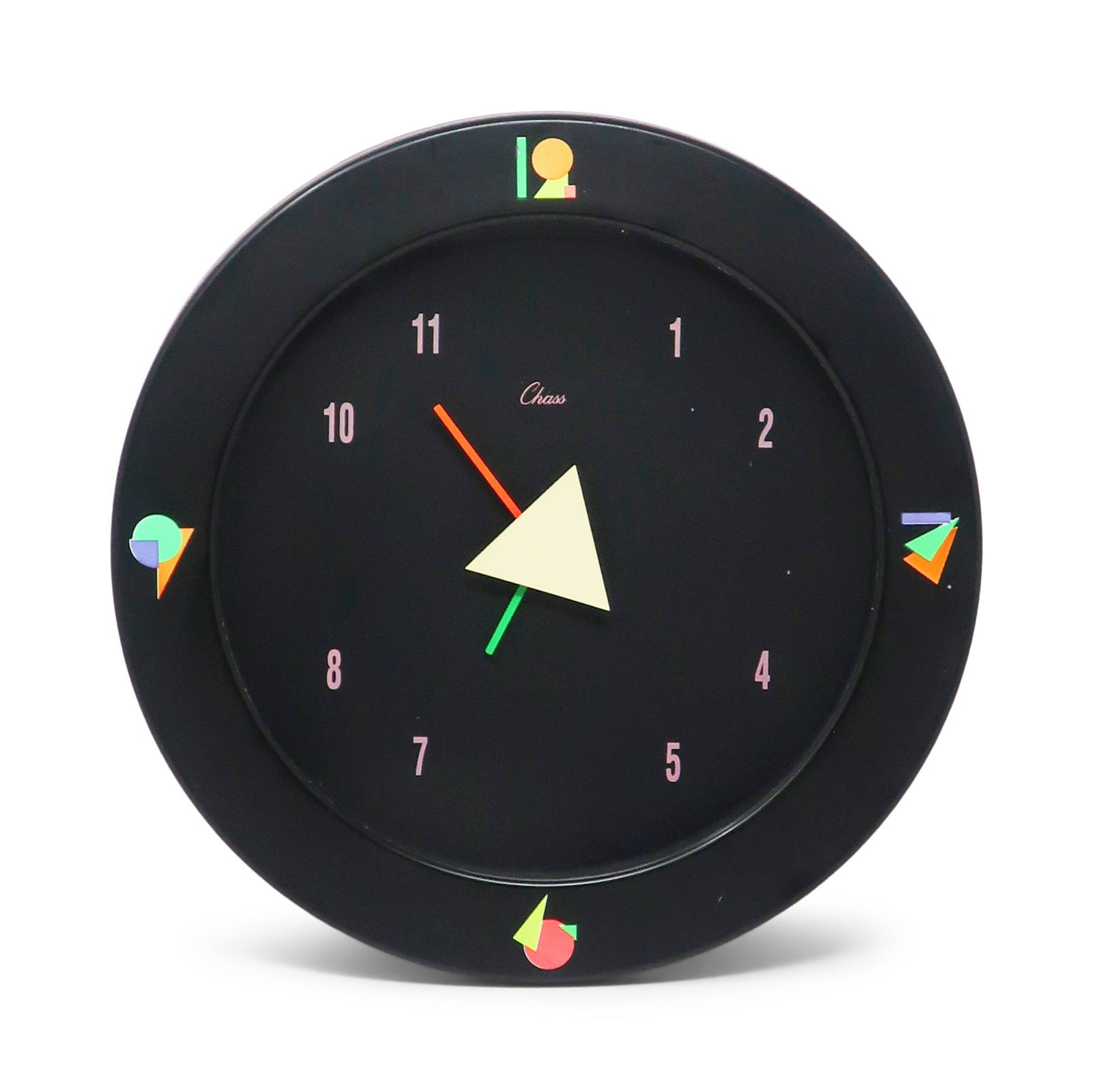 1980s Black Postmodern Wall Clock by Chass: With a vibrant 1980s touch of class, this 'Chass' Postmodern Wall Clock features a black case and face, pastel numbers, geometric accents, and an asymmetrical hand arrangement. Reminiscent of Memphis