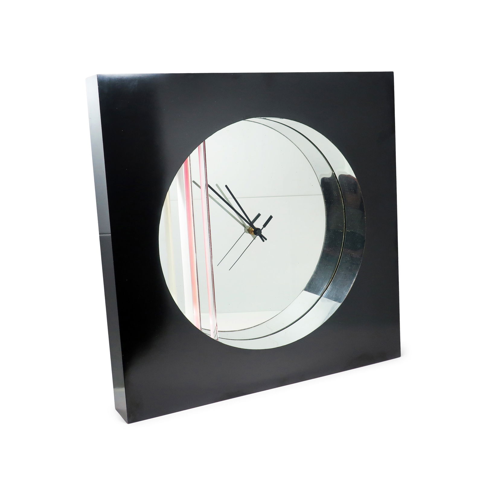 1980s Postmodern Mirror Wall Clock by Jon Gilmore for Accessory Art Studios: A beautiful mirrored wall clock designed by Jon Gilmore for Accessory Art Studios, likely in the 1980s. With a black laminate covered wood case, a round recessed mirrored face, black hands, and clear