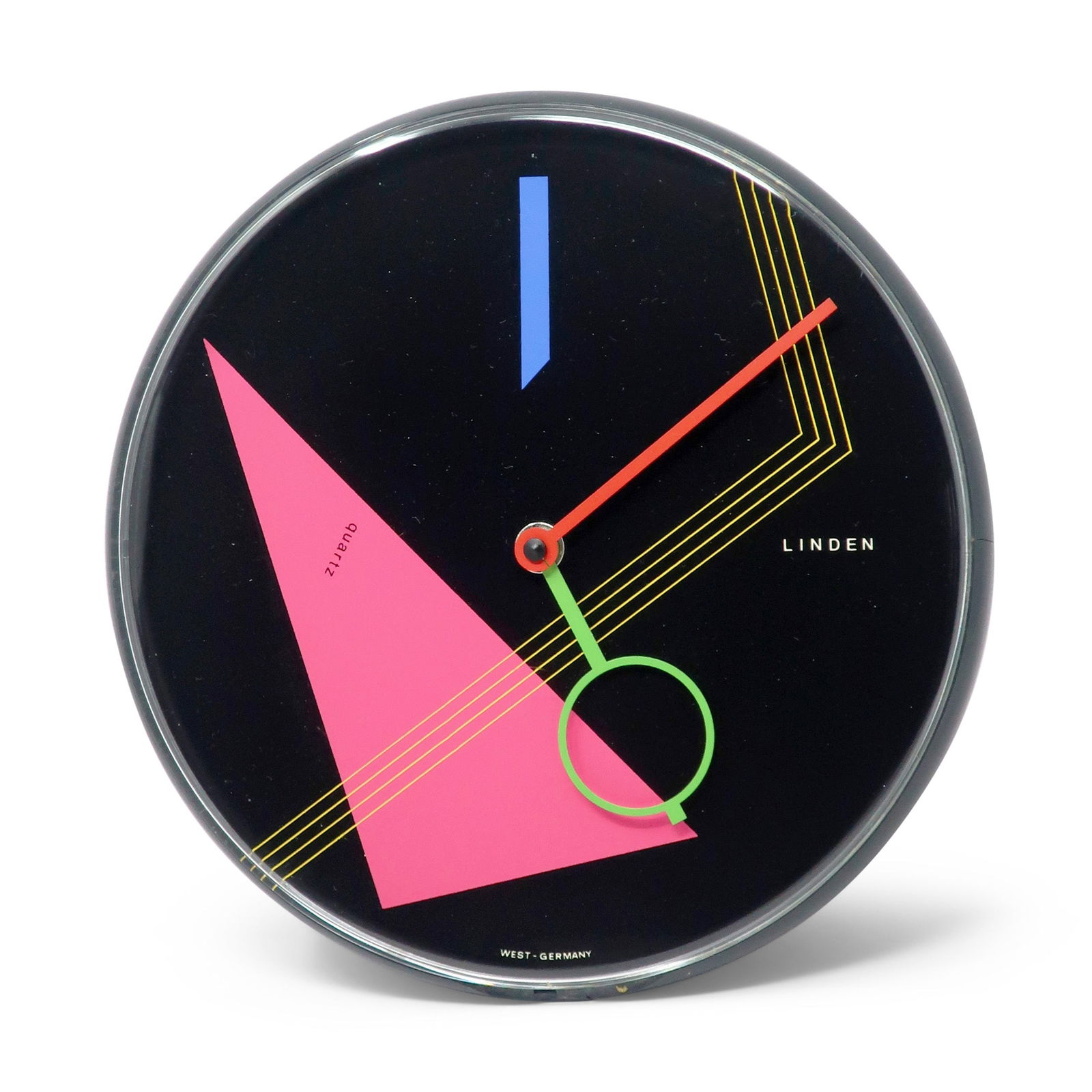 1980s Postmodern Black Wall Clock by Linden: A beautiful postmodern wall clock from the 1980s by West German clockmaker Linden. It has a black case, black face with geometric accents, and red and green hands, Striking contrast and fantastic pop