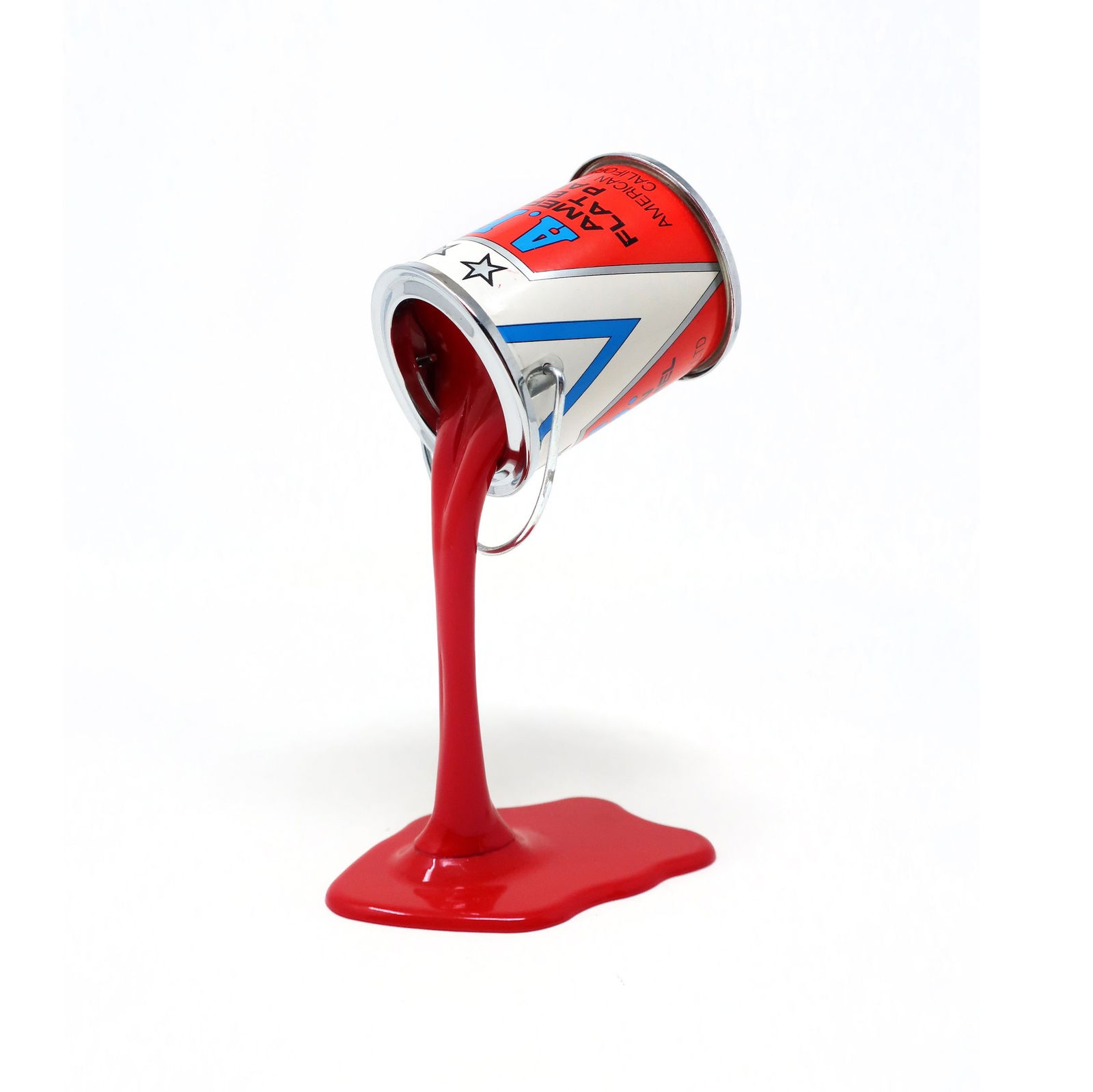 Vintage Red Pop Art APC Pouring Paint Can Bank: A perfectly Pop Art 1980s pouring paint can piggy bank/sculpture. Metal paint can with a quarter-sized coin slot in its bottom appears to be defying gravity by resting on a pouring stream of paint. So