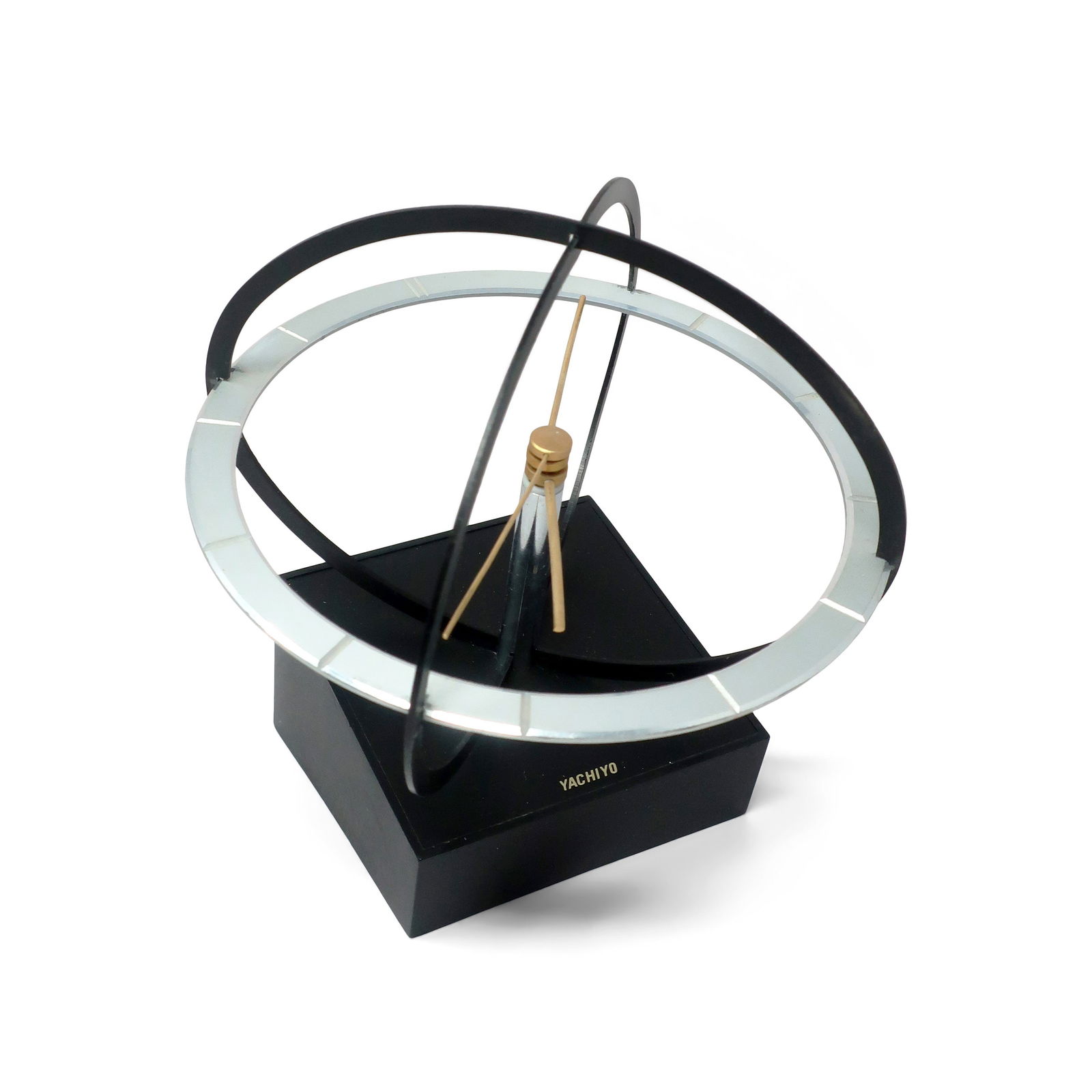 Mid-Century Modern Space Age Kinetic Desk Clock by Yachiyo: Bringing a touch of Space Age design flair to your space, this mid century clock features a kinetic sphere design, with the clock's hands rotating within the chrome frame. This clock was made or licen