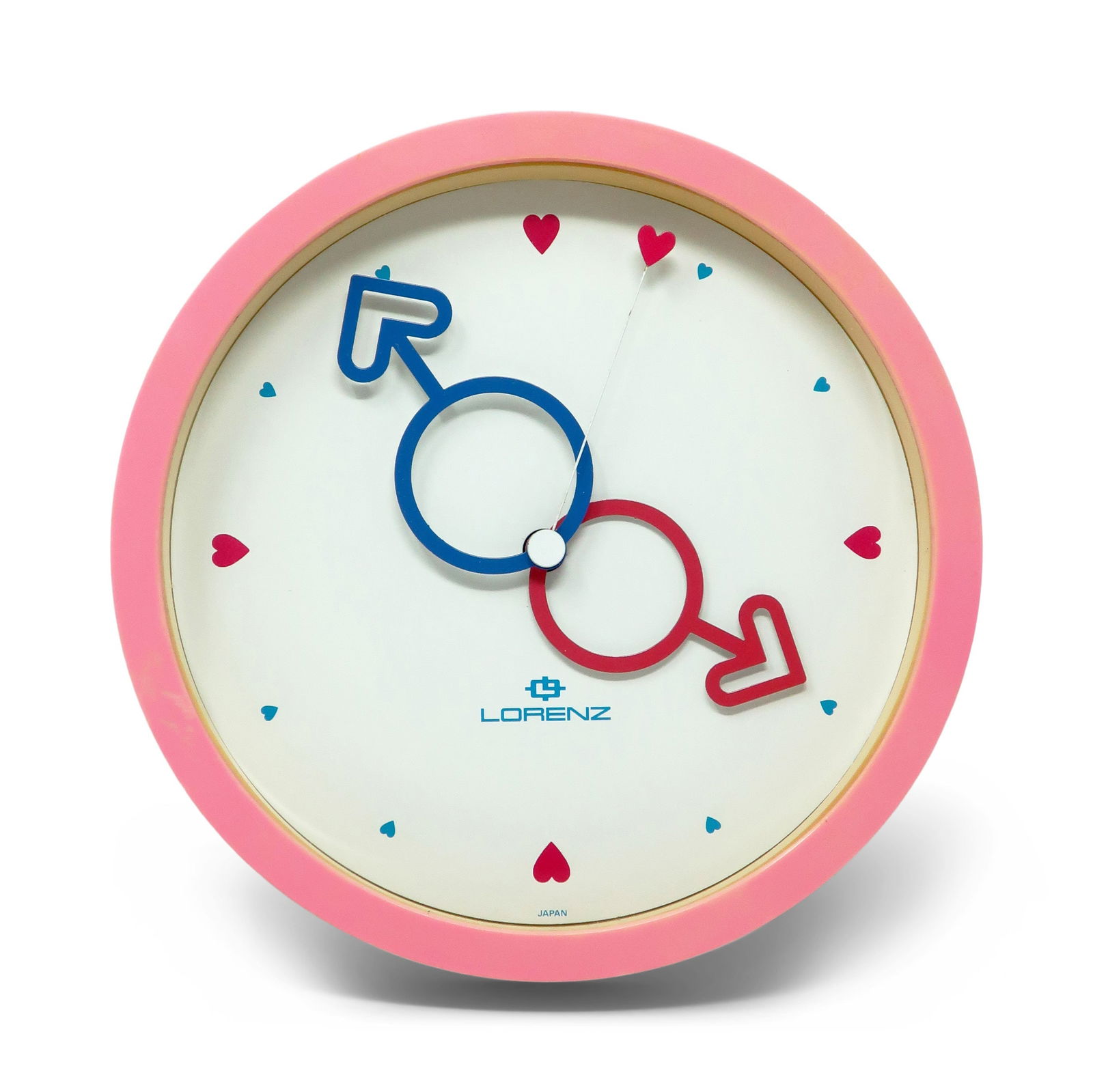 1980s Pink Heart Wall Clock by Lorenz: A fun round postmodern Lorenz wall clock with multi-color accents from Japan. A pink case, white face, red and blue heart hands, red heart second hand, and red and blue hearts for numbers. Bright, col