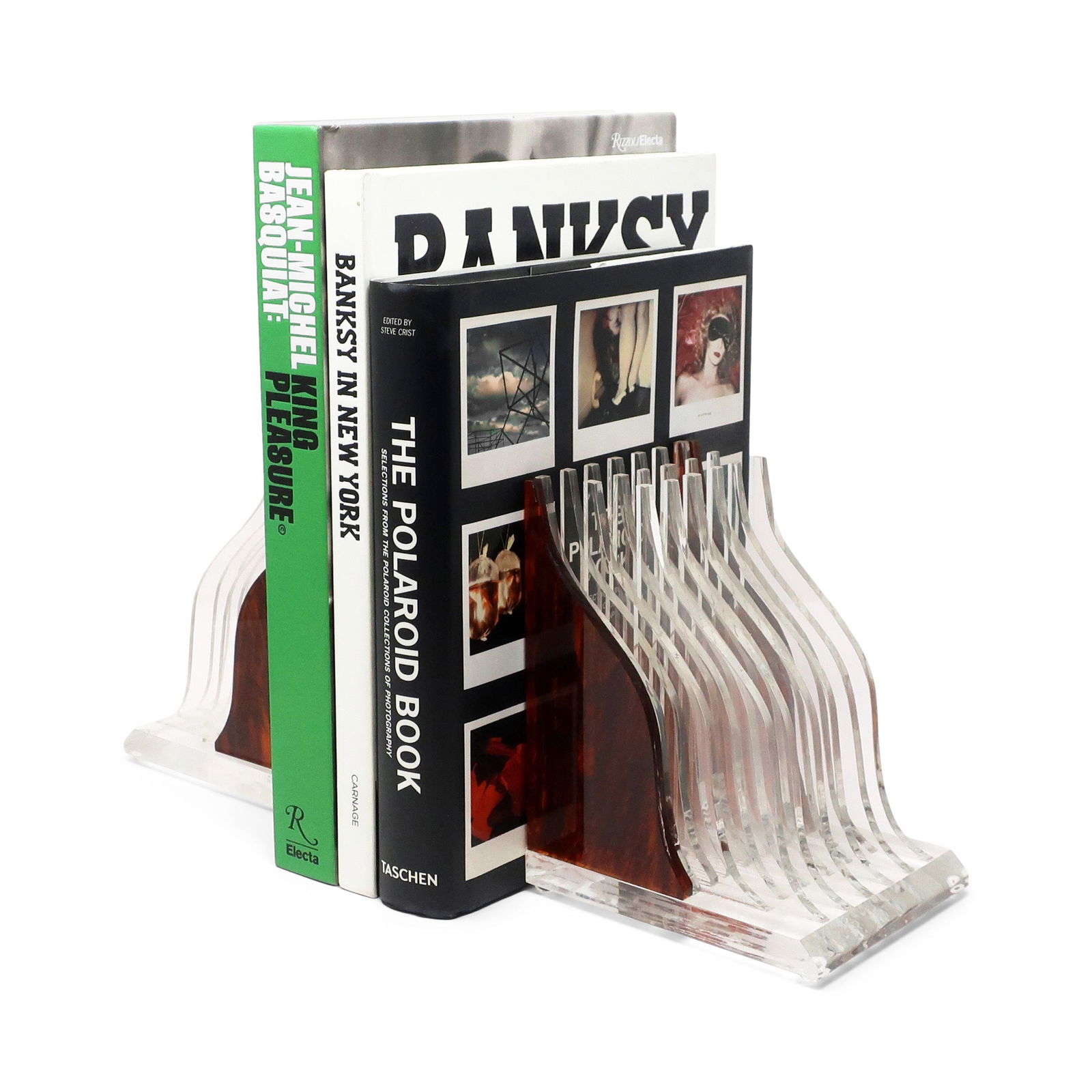 Pair of Vintage Stacked Tortoiseshell Lucite Bookends: A very special pair of vintage stacked tortoiseshell and clear lucite bookends. The design has hints of Art Deco and Hollywood Regency and is an eye-catcher in any library, office, or living room. In