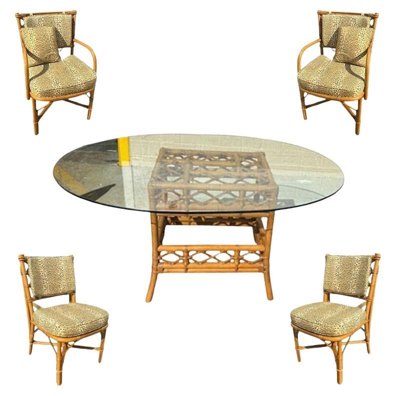 Restored Mid-century Rattan Dining Table & Chairs w/ Leopard Print Cushions: Title: Restored Mid-century Rattan Dining Table & Chairs w/ Leopard Print Cushions Description: Elevate your dining experience with his beautifully restored, exquisite dining table set featuring a sin