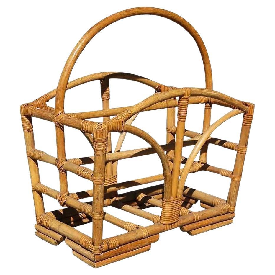 Restored Rattan Magazine Rack W/ Stacked Base: Title: Restored Rattan Magazine Rack W/ Stacked Base Description: Pole rattan magazine rack with stacked base and sprouting side decoration. 1950, United States We only purchase and sell the best and