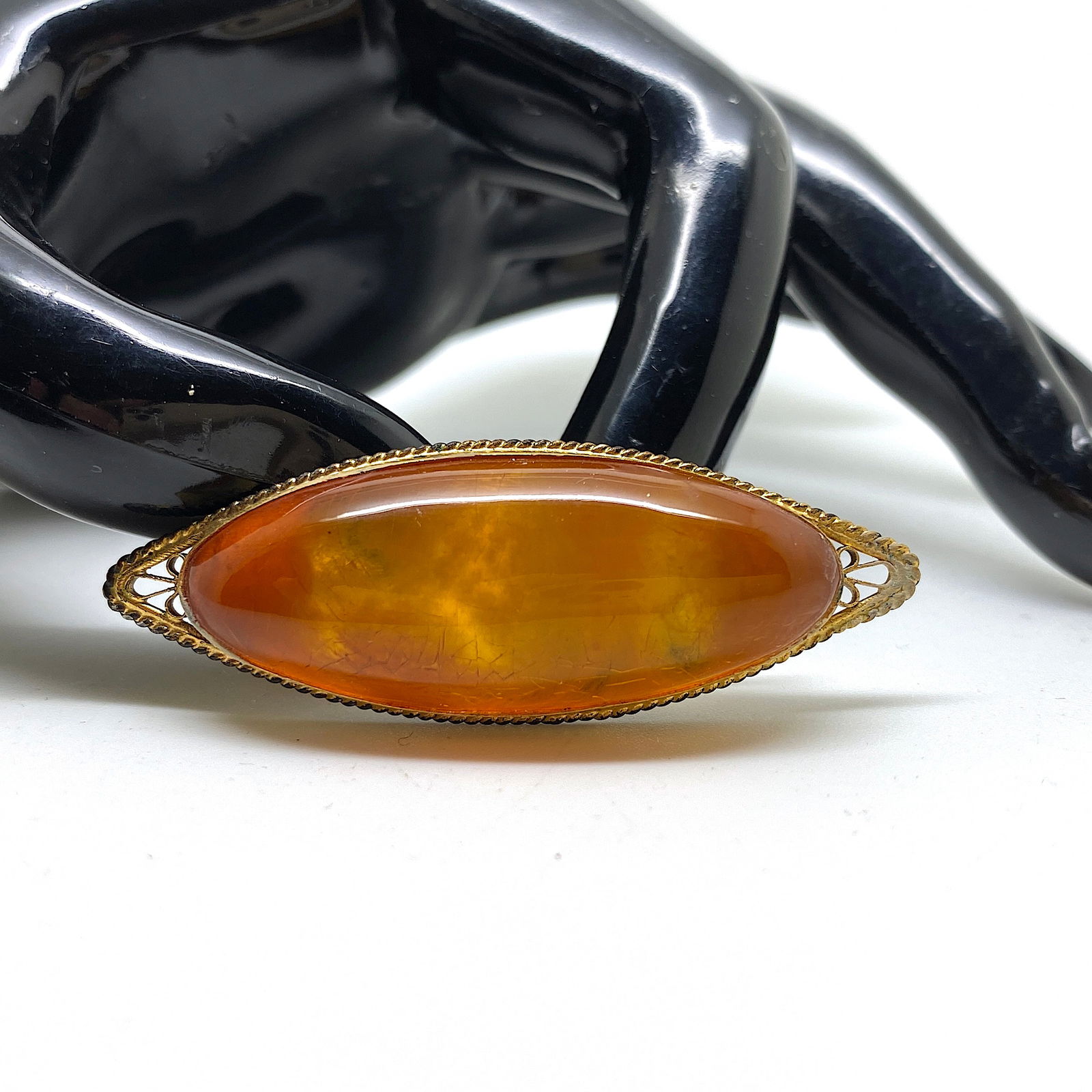 Phenomenal Amber Brooch: Title:Phenomenal Amber Brooch Metal:None Gemstone:Amber Weight:6.2 g Size:Size: 53.0 x 19.0 x 10.0 mm Size: 2.087 x 0.748 x 0.394 inches Made of:(Reconstituted Amber or Whole Stone):Reconstituted Ambe