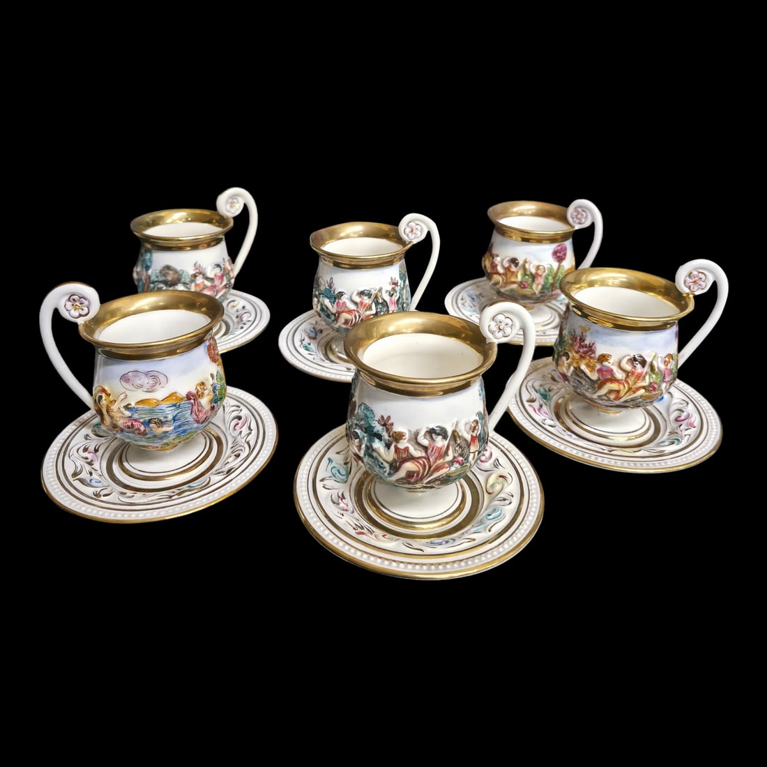 1950s Vintage Porcelain Tea Cup & Saucer Set Hand-Painted White, Gold & Jewel Tones- 12 Pieces: An elegant six-piece porcelain tea cup and saucer set, hand-painted in white with rich gold trim and jewel-tone burgundy, green, … Read more An elegant six-piece porcelain tea cup and saucer set