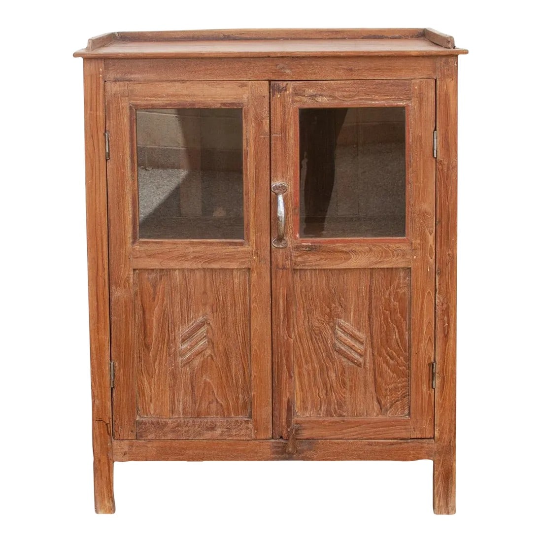 Vintage Teak Glass Kitchen Cabinet: A handsome antique British colonial cabinet with timeless elegance. Constructed from high-quality teak wood, this early 20th century cabinet showcases exceptional craftsmanship with two doors. Retaini