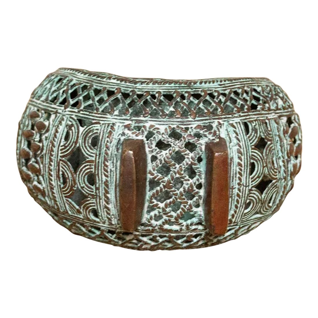 Pierced Copper African Currency Bracelet: This striking anklet, crafted in Cameroon between the early and mid-20th century, served as currency for the Bamum people. Hand-cast using the lost-wax method, the thick copper alloy boasts a