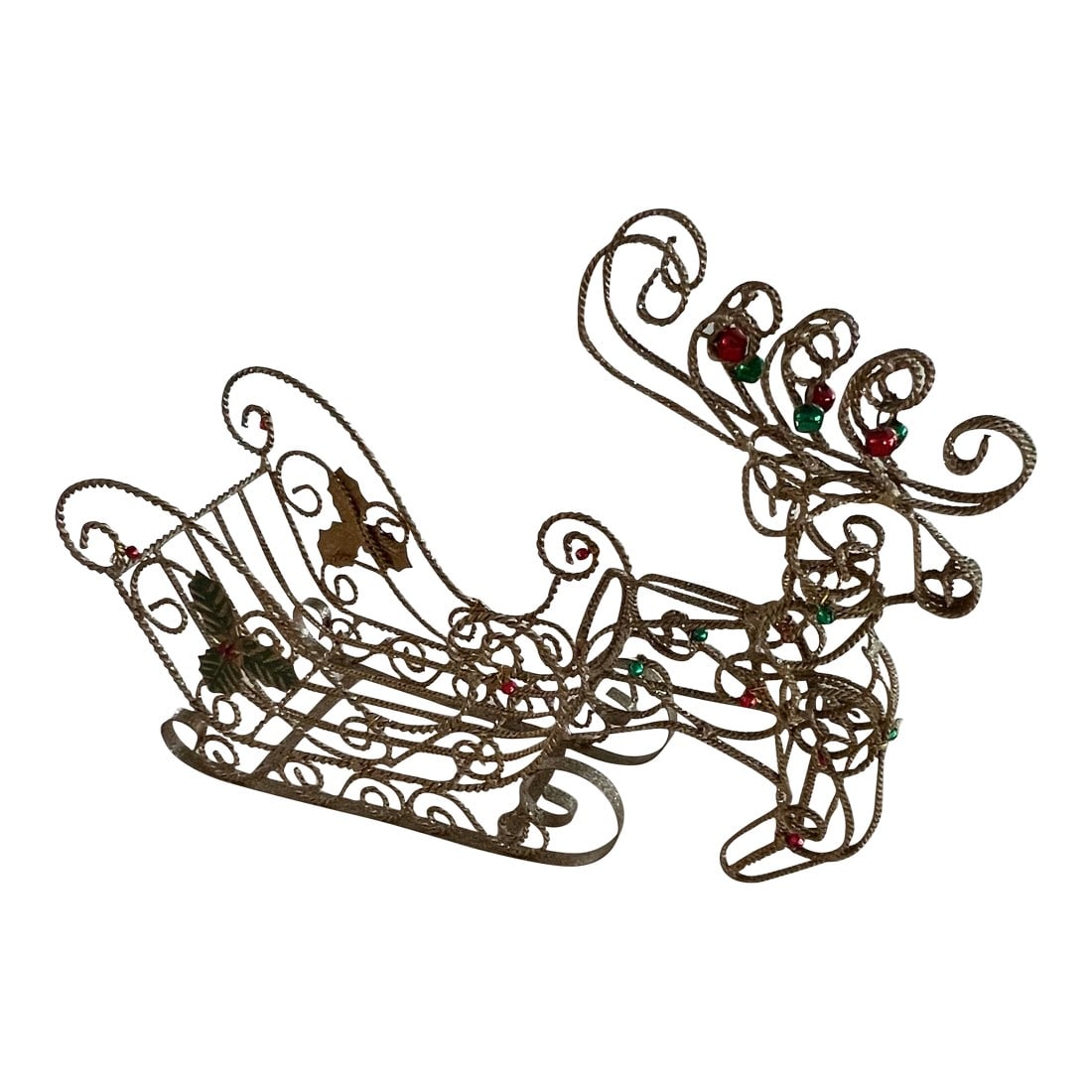 Vintage Gold Twisted Wire Reindeer and Sleigh: Large reindeer and sleigh Christmas decoration. Pretty enough to stand on its own or fill it with presents or ornaments, its uniqueness is sure to be a conversation starter. The sleigh is covered in