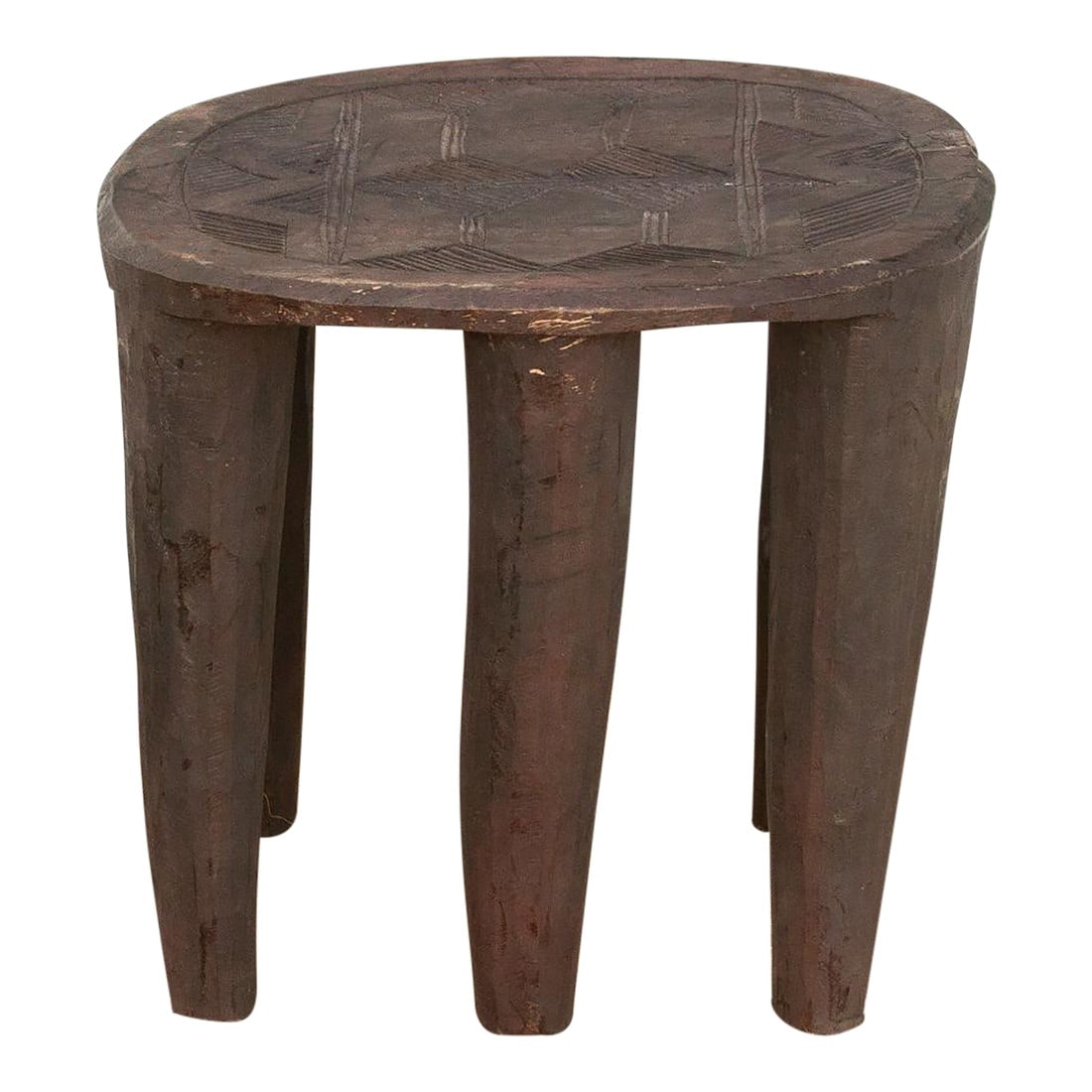 Vintage Carved Top Cone Legs End Table: A unique piece of African art, this vintage Nupe table from Nigeria is a must-have for collectors and enthusiasts of Nupe culture. Carved from a single log of wood and standing on 6 chunky tapered leg