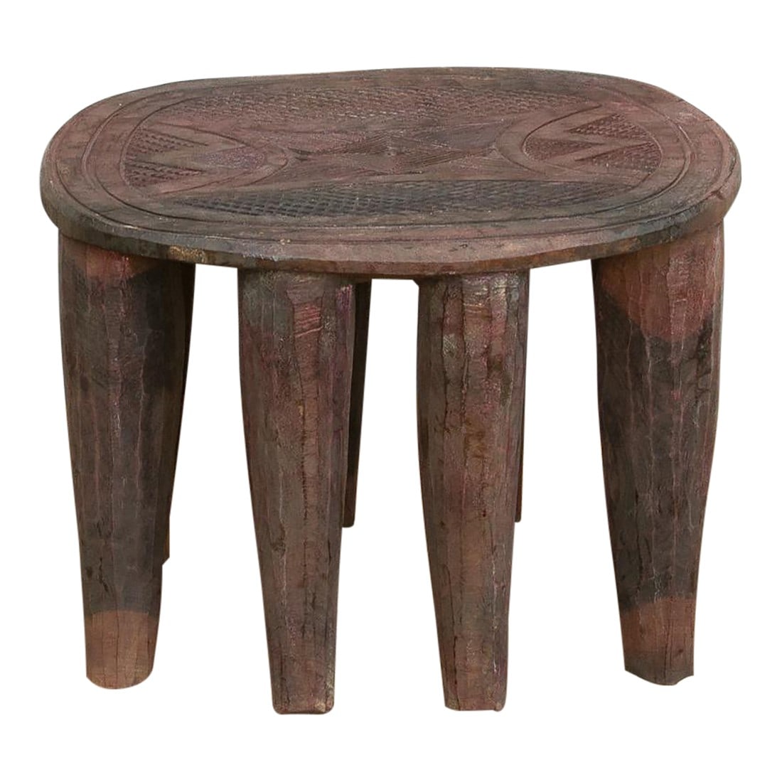 Vintage Nupe Oval Small Coffee Table: A unique piece of African art, this vintage Nupe table from Nigeria is a must-have for collectors and enthusiasts of Nupe culture. Carved from a single log of wood and standing on 8 chunky tapered