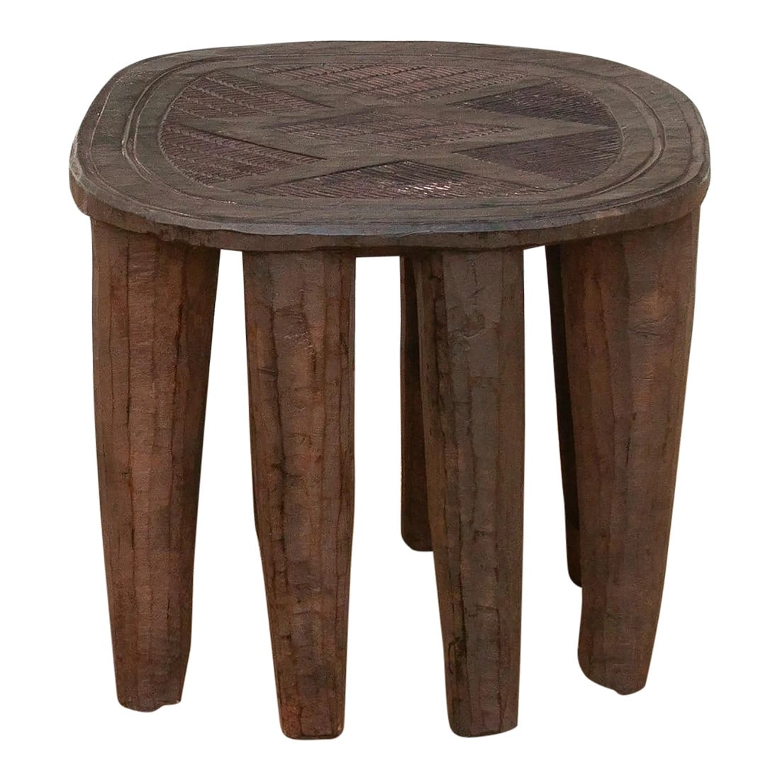 Vintage African Table Carved From a Single Log: A unique piece of African art, this vintage Nupe table from Nigeria is a must-have for collectors and enthusiasts of Nupe culture. Carved from a single log of wood and standing on chunky tapered legs,