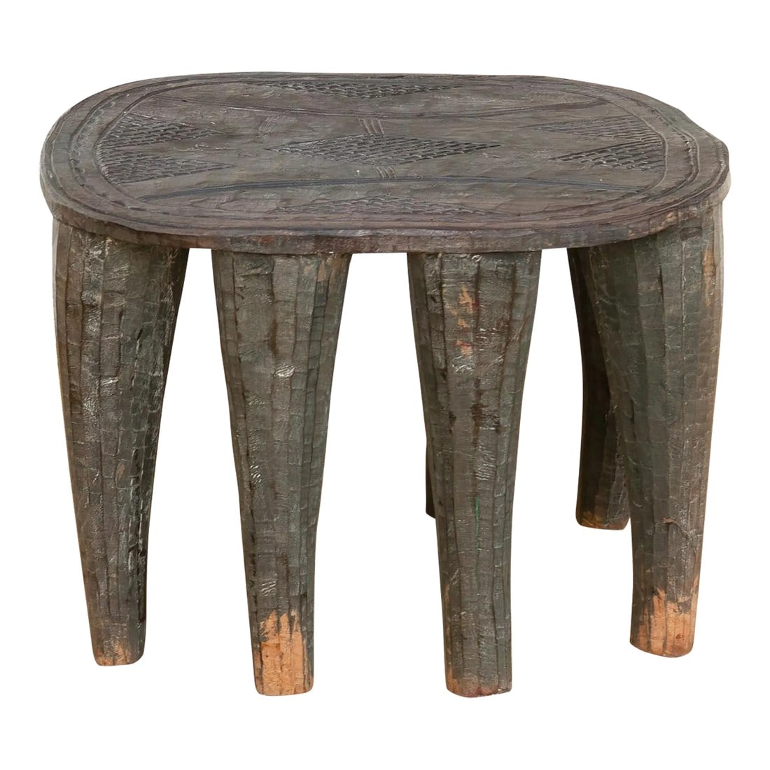 Perfectly Imperfect Carved Wood Side Table: A unique piece of African art, this vintage Nupe table from Nigeria is a must-have for collectors and enthusiasts of Nupe culture. Carved from a single log of wood and standing on 8 chunky tapered leg