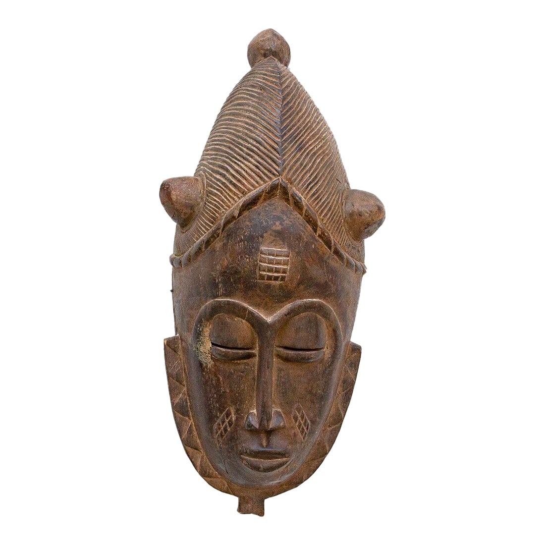 Carved Senufo Mask, Guardian of the Poro: This imposing Senufo Kpelie mask from the Ivory Coast is a striking example of African tribal art. The mask is characterized by its large size, fierce expression, and elaborate headdress. The surface