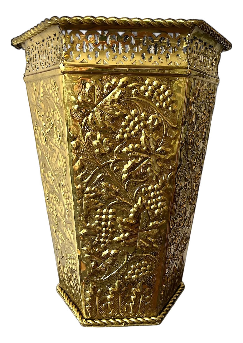 Vintage Lacquered Brass Hexagonal Embossed Wastebasket With Gallery Rim and Rope Detail: Vintage lacquered brass hexagonal wastebasket, featuring intricately embossed grapevine motifs and a pierced gallery rim for an added touch of sophistication. With its lustrous golden finish and