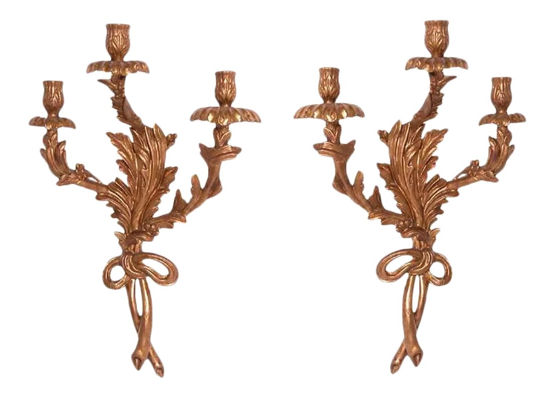 Pair of Traditional Italian Three Light Hand-Carved Wood Sconces: Very special three light hand-carved wood sconce with leaf and bow design in an Vintage gold gilt finish. The artisan on these sconces was chosen to restore the famed La Fenice Theater in Italy