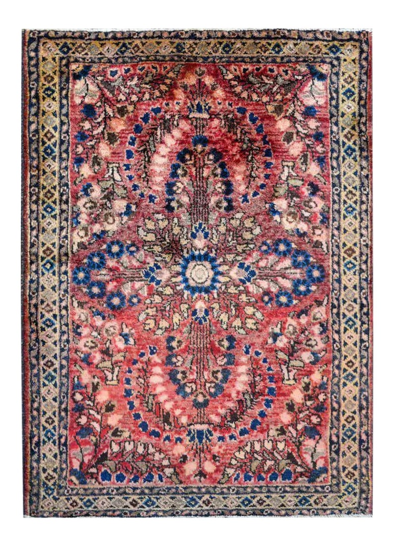 Traditional Early 20th Century Sarouk Rug: A traditional early 20th century Persian Sarouk rug with a mirrored tree-of-life pattern woven in indigo, brown, beige, and pink vegetable dyed wool on an abrash cranberry background surrounded by a