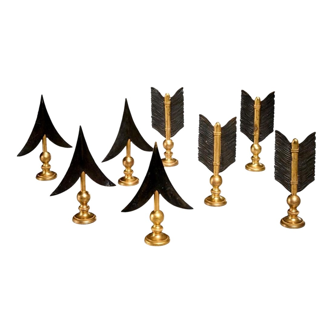 Set of 8 Arrow Head and Flight Drapery Rod Finials, 1980s: 20th c., unmarked, gilt and patinated metal, each arrowhead 7"h x 4.75"w x 1.75"d, each flight 6.5"h × 2.75"w x 1.75"d. Extremely well executed and in fine shape. Black and gold ornamentation. 